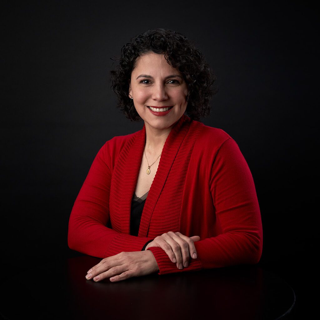 Foto para LinkedIn de mujer vestida de rojo en fondo negro muy classico